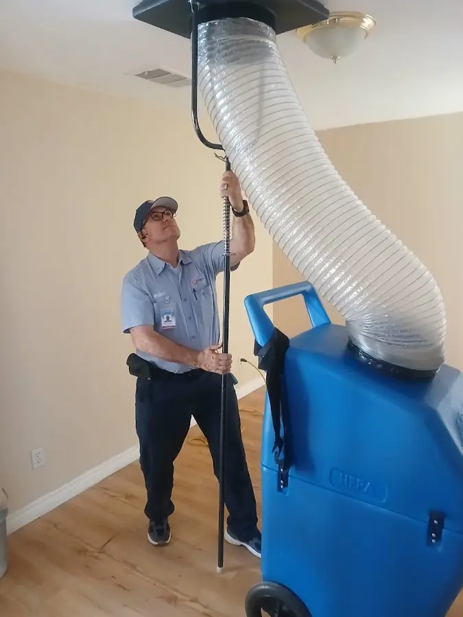 Furnace Tune-Up technician using HEPA equipment in Corrales